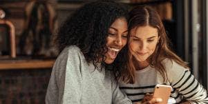 two friends looking at a phone
