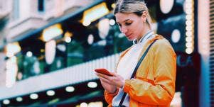 woman in orange texting