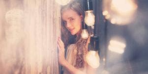 woman surrounded by lightbulbs