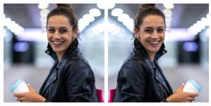 woman standing in a bright hallway, smiling