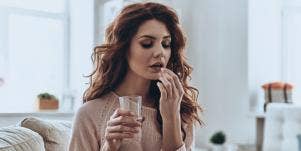 woman taking pill