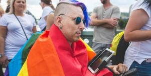 man wearing rainbow flag