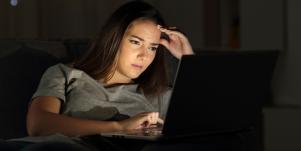 woman looking at computer screen looking distraught