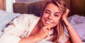 woman in bed winking