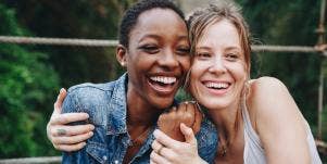black woman with white woman hugging