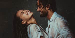 Couple laughing in the rain together