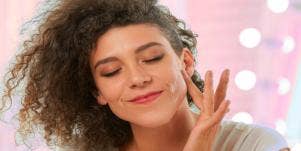 woman putting moisturizer on face