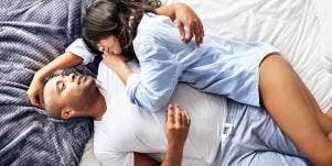 man and woman lying on bed
