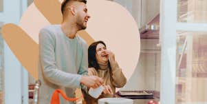 Couple in kitchen together laughing
