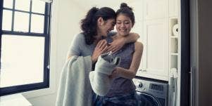 happy mom with daughter doing laundry