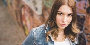 woman in jean jacket looking at camera