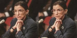 Justice Ruth Bader Ginsburg, in middle age, sits in front of a microphone wearing a grey suit, listening intently