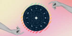zodiac wheel between two hands