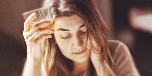 woman holding a glass of alcohol