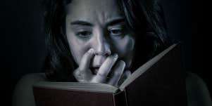 scared woman reading a book