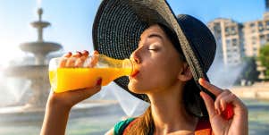 woman drinking orange juice