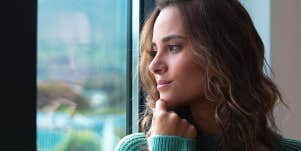 woman looking out window