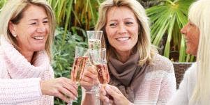 three older women toasting wine