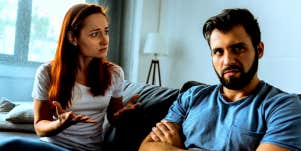 woman sitting on couch fighting with her selfish husband