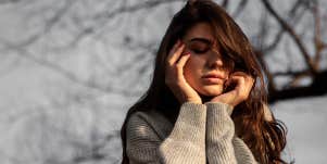 woman with hands on chin
