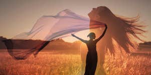 woman in field at sunset