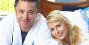 couple in robes in bed