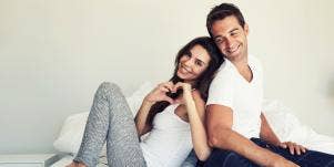 couple wearing white in bed