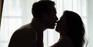 man kissing woman in shadow