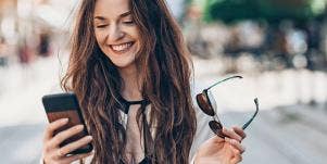 happy woman looking at her phone