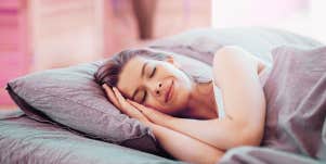 woman smiling in bed sleeping