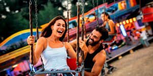 husband and wife having fun at a carnival