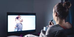 woman watching couple on tv and eating ice cream