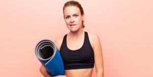 uncertain woman with yoga mat