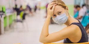 Woman waits in a hospital, upset
