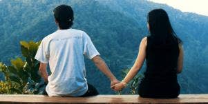 couple holding hands at overlook