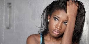 woman looking frustrated putting her hand through her hair