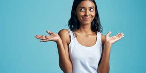 woman smiling and shrugging