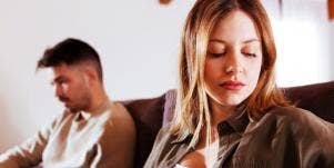 couple looks away from each other, man shows signs of cheating