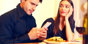 woman thinking about divorce while sitting next to her husband looking at his phone