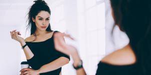 woman looking in mirror