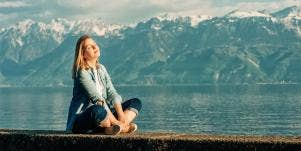 woman sitting in front of mountains