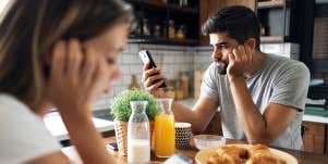 couple on phones ignoring each other at breakfast table