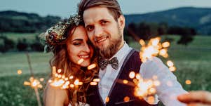 man and woman with sparklers