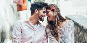 man and woman nuzzling foreheads
