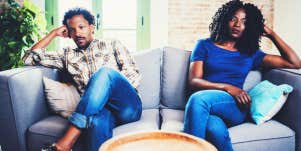 unhappy marriage couple sitting on a couch not looking at each other