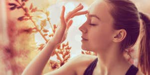 woman touching the center of her forehead