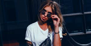 woman pulling sunglasses down