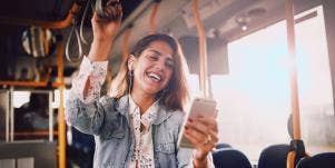 woman on her phone on the bus