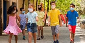 school kids walking while wearing masks