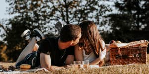 couple kissing on picnic date